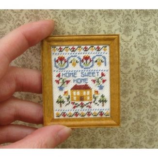 Dollhouse needlepoint sampler Home sweet home held for scale
